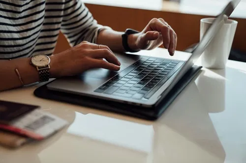 Image of a person pointing to a tablet screen showing a chart